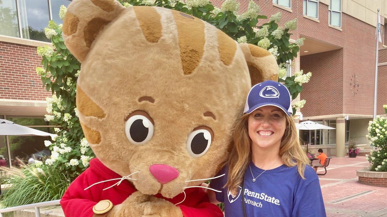 Brooke Greybush poses with the Daniel Tiger mascot