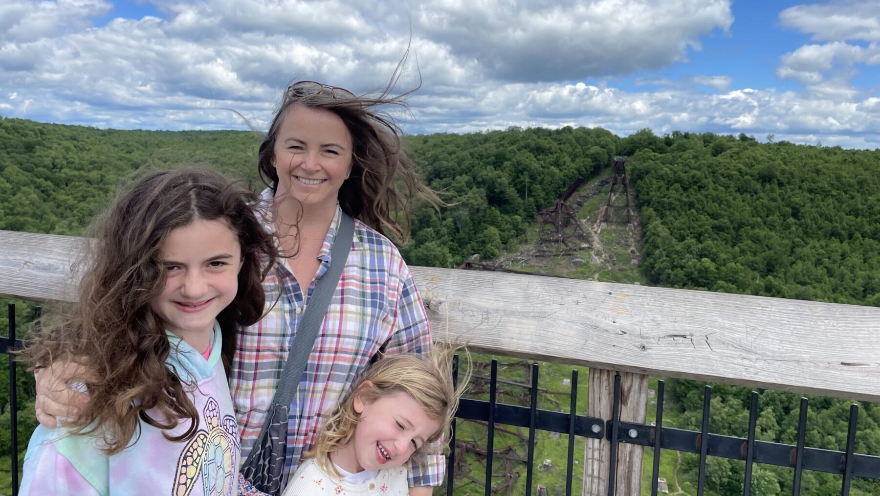 Jennifer Day Neely posing with her family at an overlook