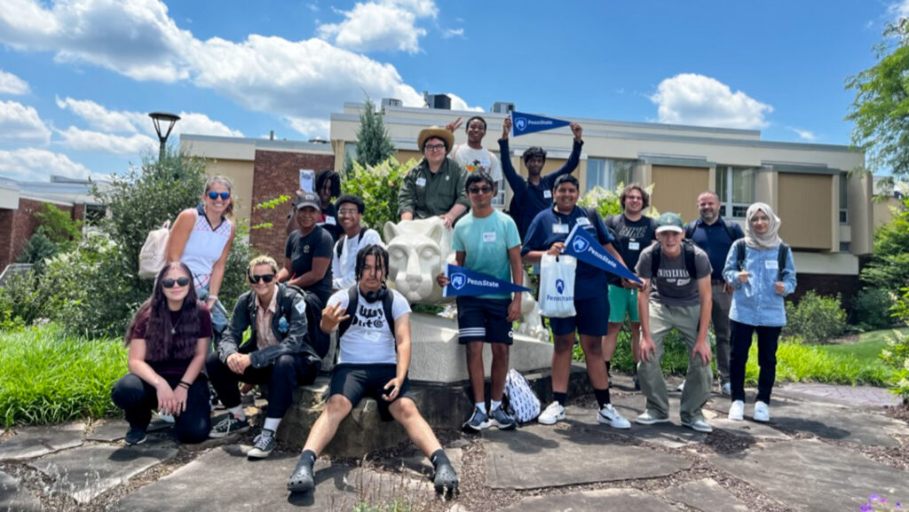 A group photo of students in front of the Lion Shrine